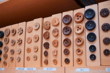 Choosing a button for clothes at a handicraft store