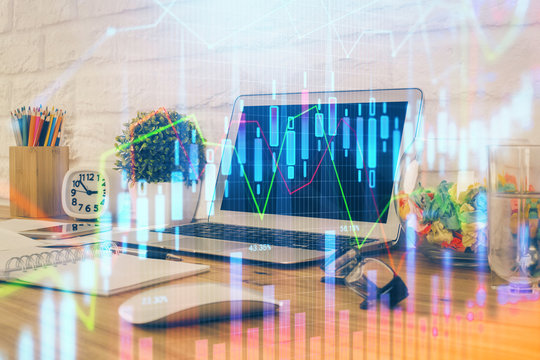 Financial graph colorful drawing and table with computer on background. Multi exposure. Concept of international markets.
