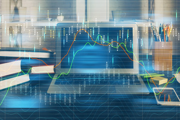 Double exposure of graph and financial info and work space with computer background. Concept of international online trading.