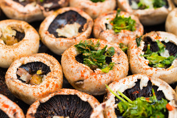 Baked mushrooms, roasted with fresh coriander and garlic. Vegan food. Stuffed champignon.