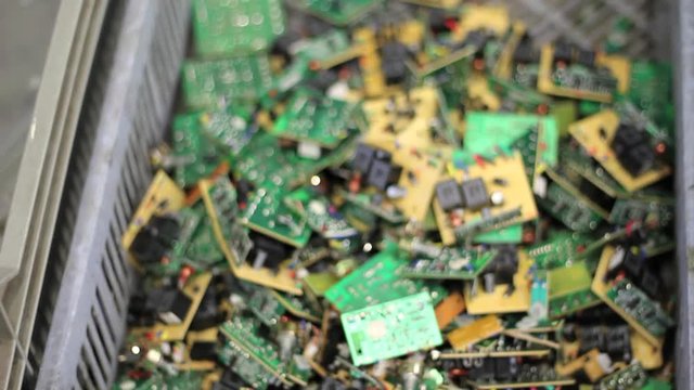 Moving over recycled circuit boards in basket