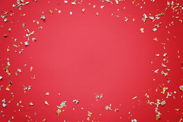 Red festive background with confetti and empty space. New year minimal pattern.