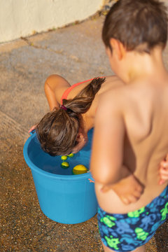 Young boy and girl Bobbing for Apples