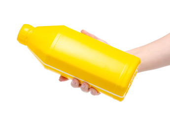 Yellow bottle industrial primer in hand on white background isolation