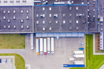Aerial view of warehouse storages or industrial factory or logistics center from above. Aerial view of industrial buildings and equipment machines at sunset, toned