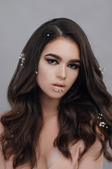 Naklejka premium Beautiful woman with long smooth hair shine and healthy beauty skin isolated on grey natural makeup