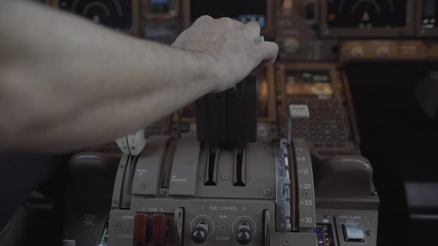 Pilot push thrust lever handle for takeoff a plane in the cockpit - ungraded color