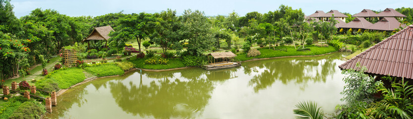 Fototapeta na wymiar Beautiful landscape of a park in Thailand. Area with Green Trees and Lake