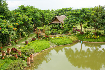 Obraz premium Beautiful landscape of a park in Thailand. Area with Green Trees and Lake
