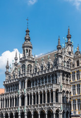 Fototapeta na wymiar Brussels, Belgium - June 22, 2019: Gray stone monumental palace with spires and statues on Grand Place, called Maison du Roi, Kings house, Broodhuis, and now Museum of City of Brussels.