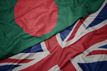 waving colorful flag of great britain and national flag of bangladesh.