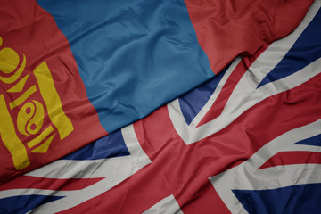 waving colorful flag of great britain and national flag of mongolia.