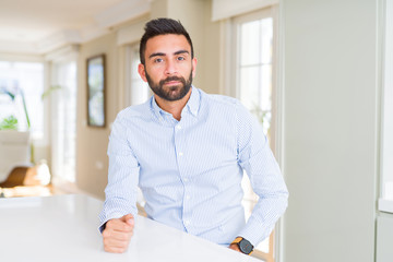 Fototapeta premium Handsome hispanic business man with serious expression on face. Simple and natural looking at the camera.