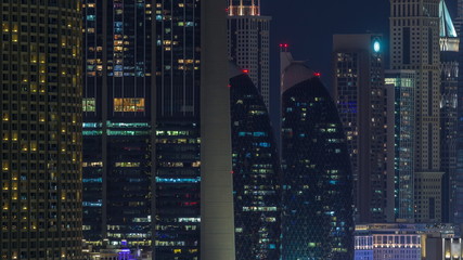 Aerial nighttime cityscape with illuminated architecture of Dubai downtown timelapse, United Arab Emirates.