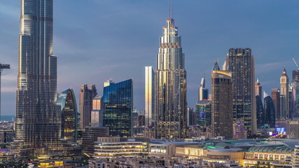 Fototapeta na wymiar Dubai Downtown skyline day to night timelapse with towers paniramic view from the top in Dubai