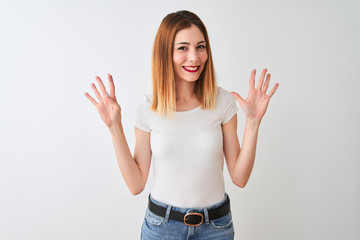 Beautiful redhead woman wearing casual t-shirt standing over isolated white background showing and...