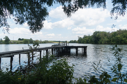 Carp fishing, rodpod with fishing  on a wooden platform on the lake
