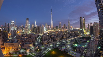 Dubai Downtown skyline night to day timelapse with Burj Khalifa and other towers paniramic view from the top in Dubai