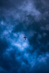 Plane silhouette on dark sky, stormy weather 