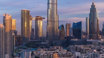 Obraz premium Dubai Downtown skyline during sunrise timelapse with Burj Khalifa and other towers paniramic view from the top in Dubai