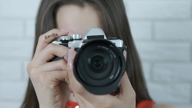 The camera in the hands of a girl close-up.