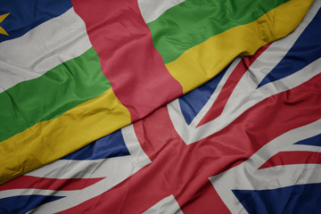 waving colorful flag of great britain and national flag of central african republic.