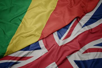 waving colorful flag of great britain and national flag of republic of the congo.