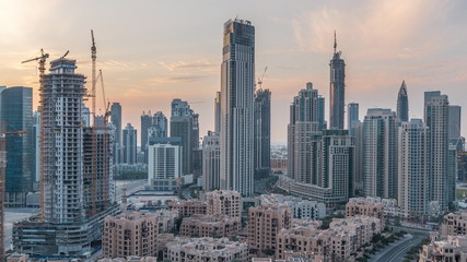 Fototapeta na wymiar Dubai Downtown skyline during sunset timelapse with modern towers paniramic view from the top in Dubai