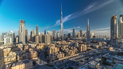 Fototapeta na wymiar Dubai Downtown skyline timelapse with Burj Khalifa and other towers during sunrise paniramic view from the top in Dubai