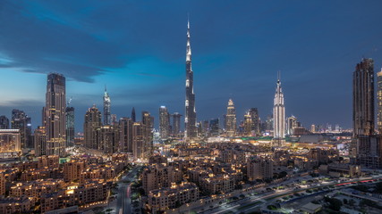 Dubai Downtown skyline day to night timelapse with Burj Khalifa and other towers paniramic view from the top in Dubai