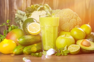 Fototapeta premium Delicious Healthy green smoothie with fruits and vegetables on table