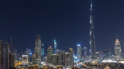 Fototapeta na wymiar Dubai Downtown skyline during all night timelapse with Burj Khalifa and other towers paniramic view from the top in Dubai
