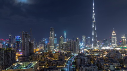 Fototapeta na wymiar Dubai Downtown skyline during all night timelapse with Burj Khalifa and other towers paniramic view from the top in Dubai