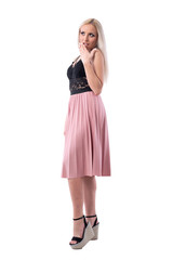 Surprised or shocked young woman with hand covering mouth looking up. Full body isolated on white background. 