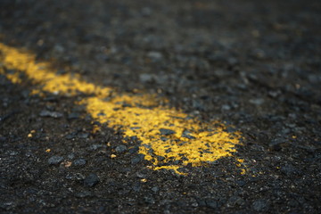 The paved road has yellow traffic lines on the surface. Blurred background Places in Thailand