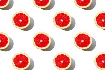 Grapefruit slices pattern isolated on white background. Minimal flat lay concept.