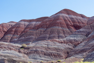 Landscape of purple, red, pink and white striped or banded hills at Paria Canyon in Grand Staircase Escalante National Monument