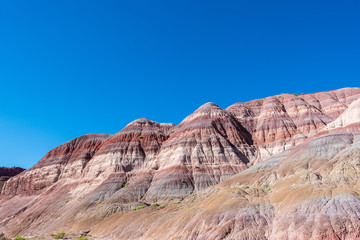 Landscape of purple, red, pink and white striped or banded hills at Paria Canyon in Grand Staircase Escalante National Monument