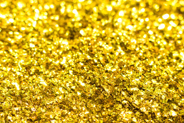 Gold glitter texture. Festive sparkling sequins background. Wpaper for Valentine, New Year or Christmas Holidays.