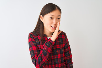 Young chinese woman wearing casual jacket standing over isolated white background hand on mouth telling secret rumor, whispering malicious talk conversation