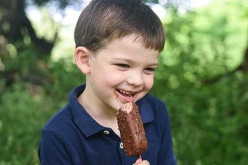 Happy little boy eating ice cream. Summer refreshment, child with ice cream