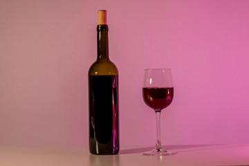 A bottle of wine and a glass