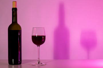 A bottle of wine and a glass