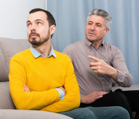 Adult father and son solve problems