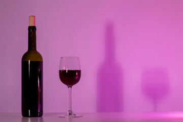 A bottle of wine and a glass