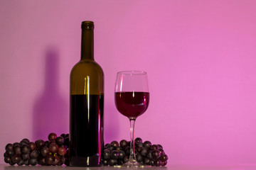 A bottle of wine and a glass