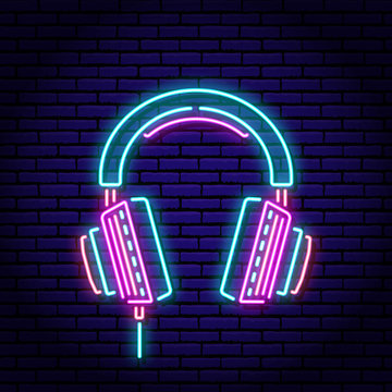 Music headphones. Neon sign on a brick wall background. Blue violet red colors