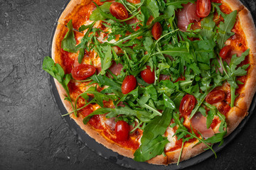 pizza with bacon and cherry on black background