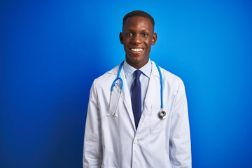 African american doctor man wearing stethoscope standing over isolated blue background with a happy and cool smile on face. Lucky person.