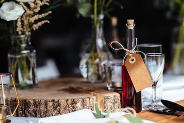 Classy wedding setting.Table setting. Fancy bottle with empty name tag.